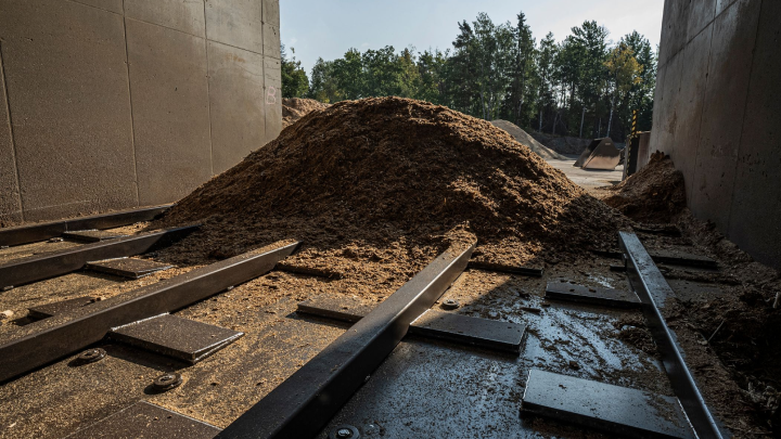 A big pile of wood chip biomass at a district heating plant.