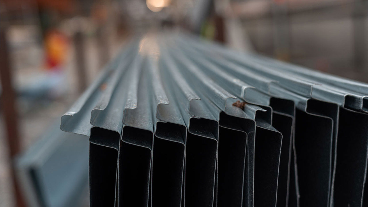 A stack of sheet metal showing the folded sides ready for joining.